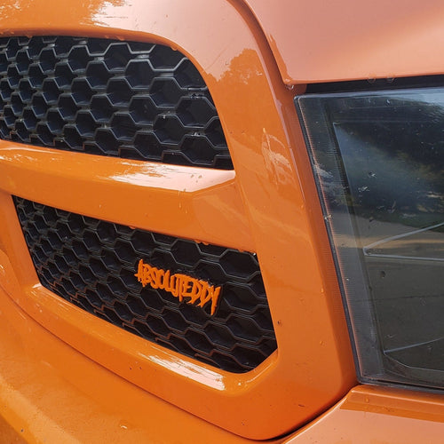 Aggressive font Custom Text Badge installed on a 4th gen RAM 1500.