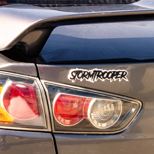 Custom Double Layer Stormtrooper Text Badge installed on a Mitsubishi Lancer.