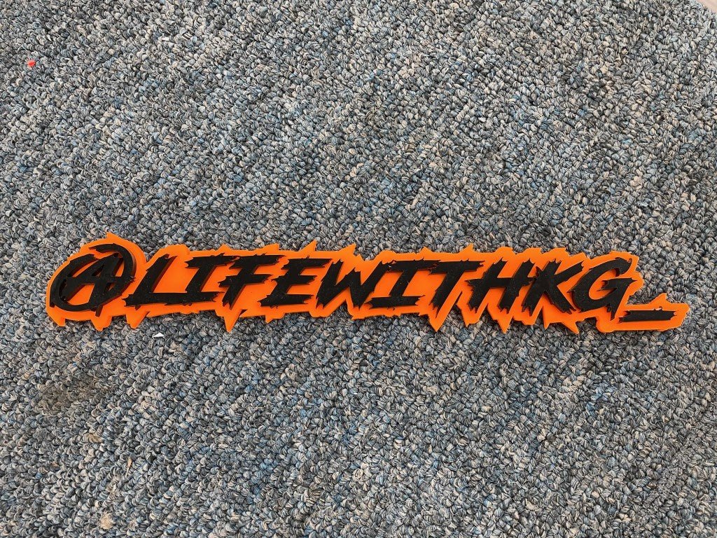 @Lifewithkg Car Badge - Gloss Black On Orange - Lightning Font - Atomic Car Concepts