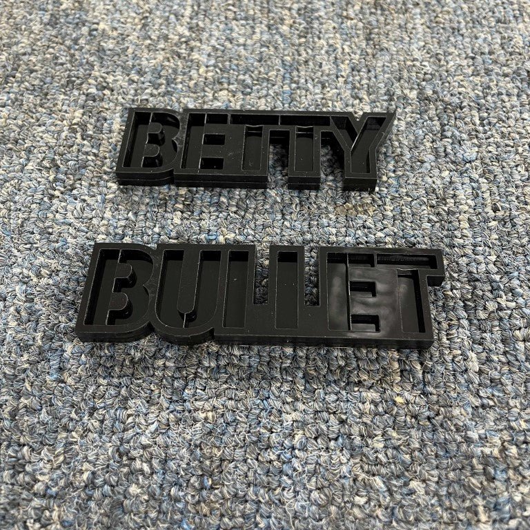 Betty Bullet Car Badge - Gloss Black On Gloss Black - Stencil Font - Tape Mount - Atomic Car Concepts