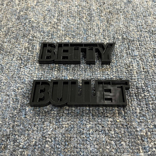 Betty Bullet Car Badge - Gloss Black On Gloss Black - Stencil Font - Tape Mount - Atomic Car Concepts