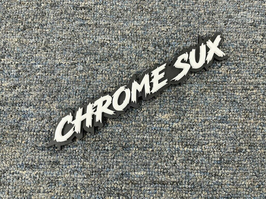 Chrome Sux Car Badge - White On Matte Black - Lightning Font