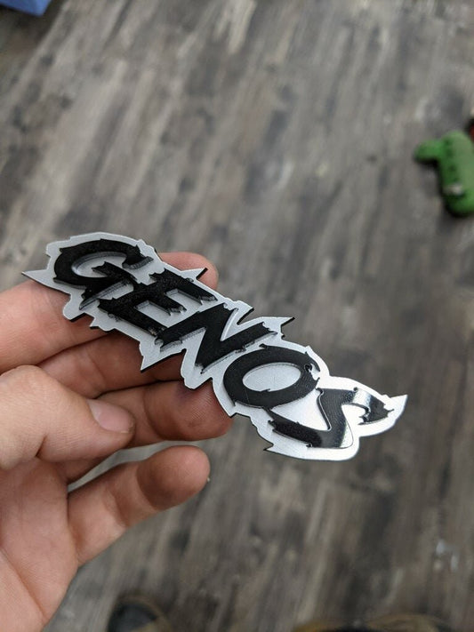 Genos Car Badge - Gloss Black On Brushed Silver - Lightning Font