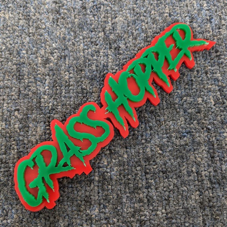 Grass Hopper Car Badge - Green on Red - Aggressive Font - Tape Mounting - Atomic Car Concepts