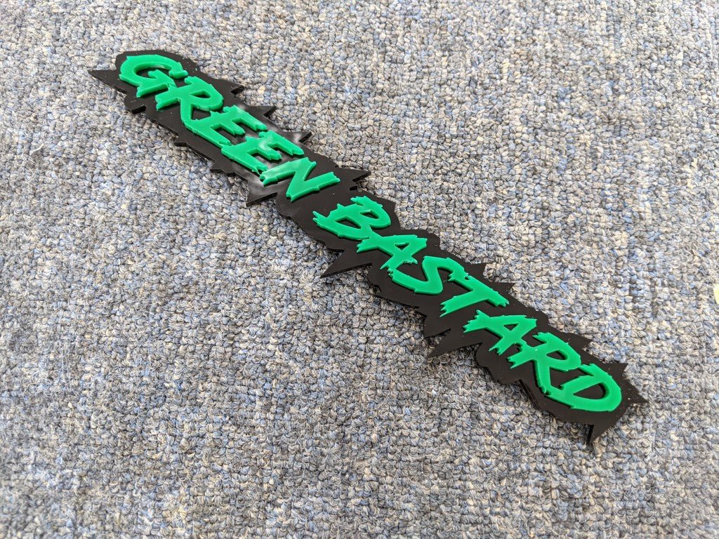 Green Bastard Car Badge - Green on Gloss Black - Lightning Font - Tape Mounting - Atomic Car Concepts