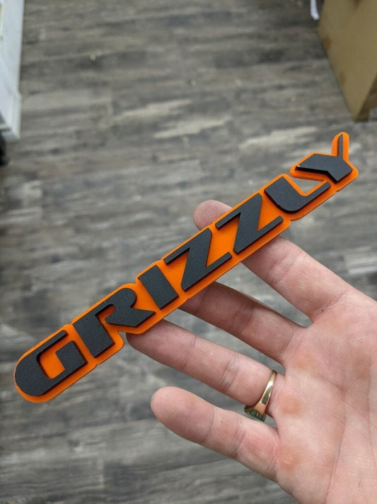 Grizzly Car Badge - Matte Black On Orange - OEM Font - Atomic Car Concepts