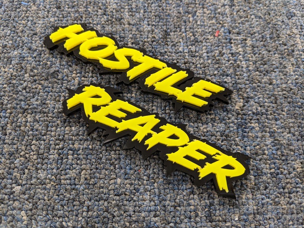 Hostile Reaper Car Badge - Yellow On Gloss Black - Lightning Font - Atomic Car Concepts