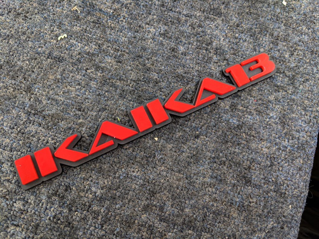 Ikaika13 Car Badge - Red on Matte Black - OEM Font - Tape Mounting - Atomic Car Concepts