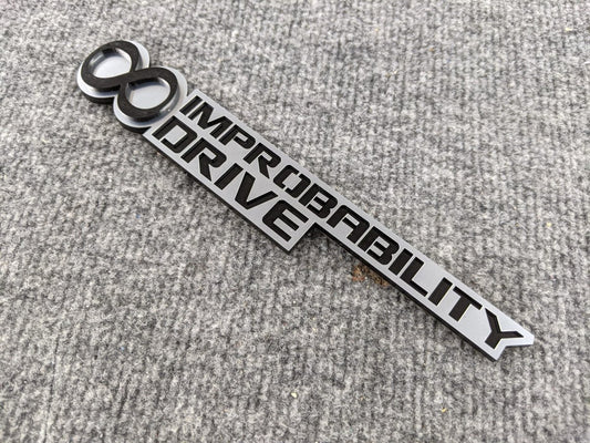 Infinite Improbability Drive Badge - Black and Brushed - Atomic Car Concepts
