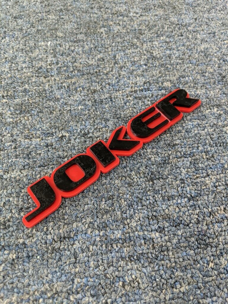 Joker Car Badge - Gloss Black On Red - OEM Font - Atomic Car Concepts