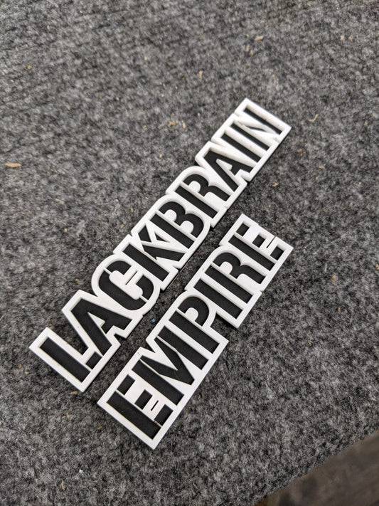 Lackbrain Empire Car Badge - White On Gloss Black - Stencil Font - Tape Mount - Atomic Car Concepts