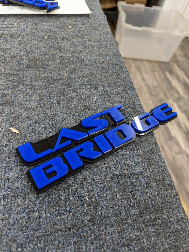 Last Bridge Car Badge - Blue On Gloss Black - OEM Font - Atomic Car Concepts