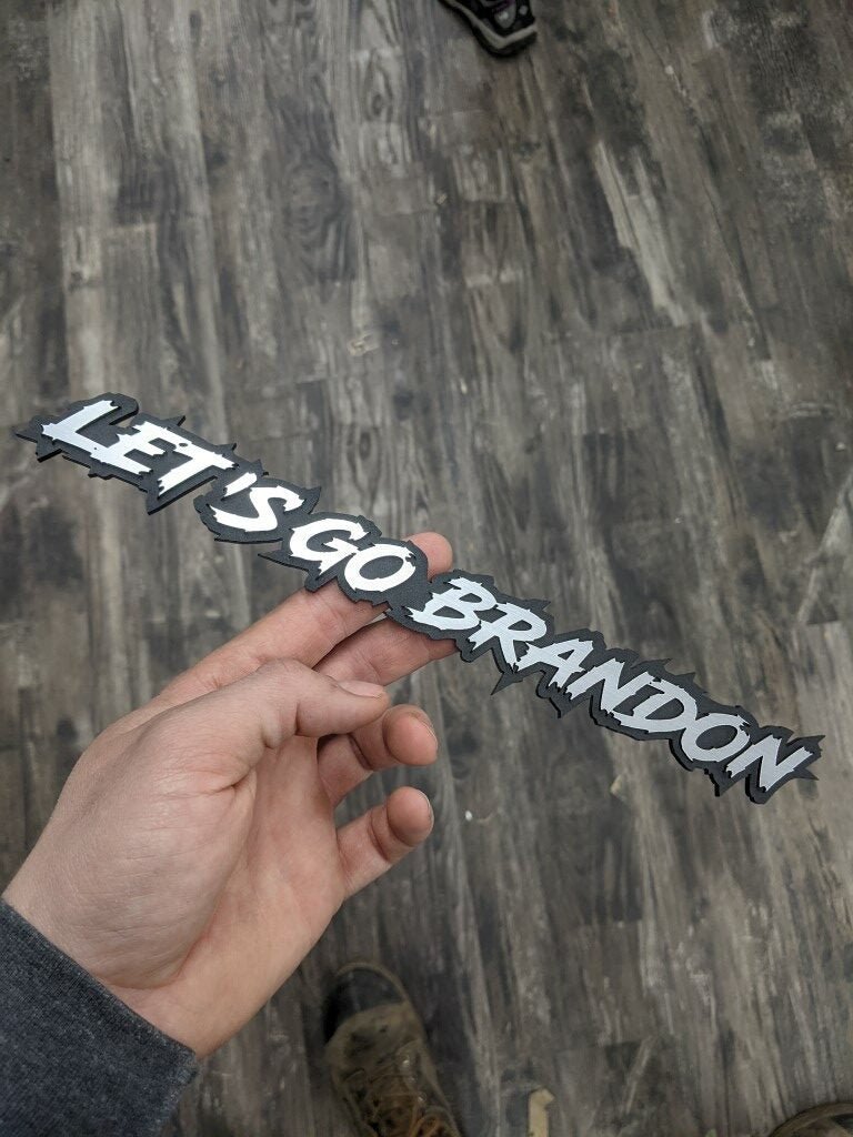 Lets Go Brandon Car Badge - Brushed Silver On Matte Black - Lightning Font - Atomic Car Concepts