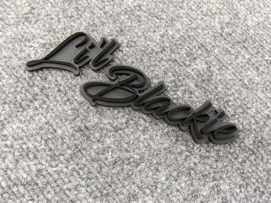 Li'l Blackie Car Badge - Gloss Black on Matte Black - Script Font - Atomic Car Concepts