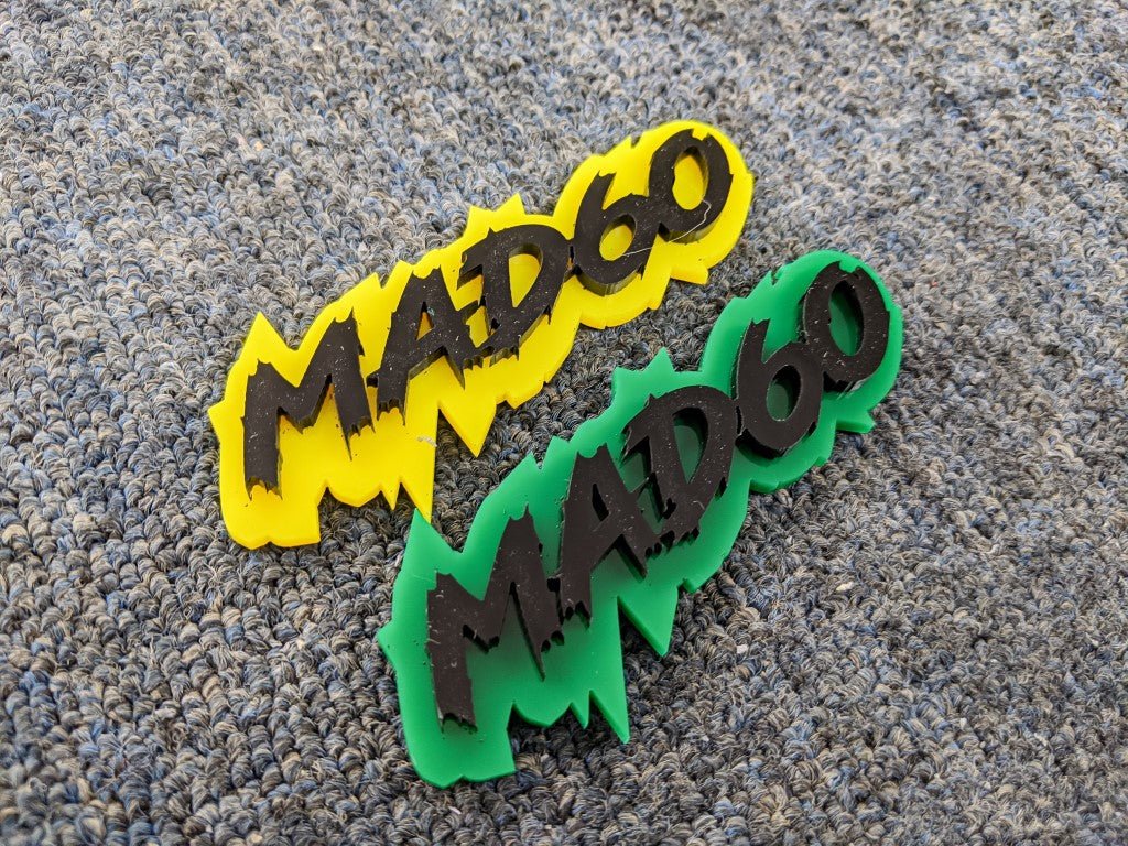 Mad60 Car Badge - Matte Black on Yellow and Green - Lightning Font - Tape Mounting - Atomic Car Concepts