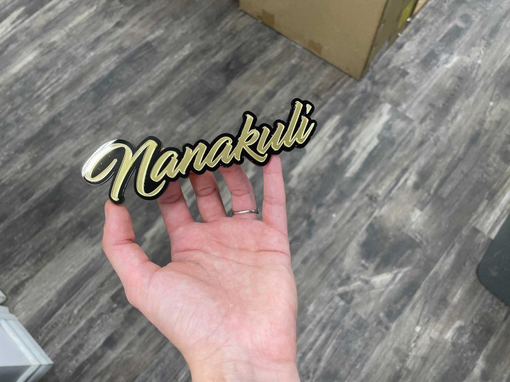 Nanakuli Car Badge - Mirror Gold On Gloss Black - Script Font - Atomic Car Concepts