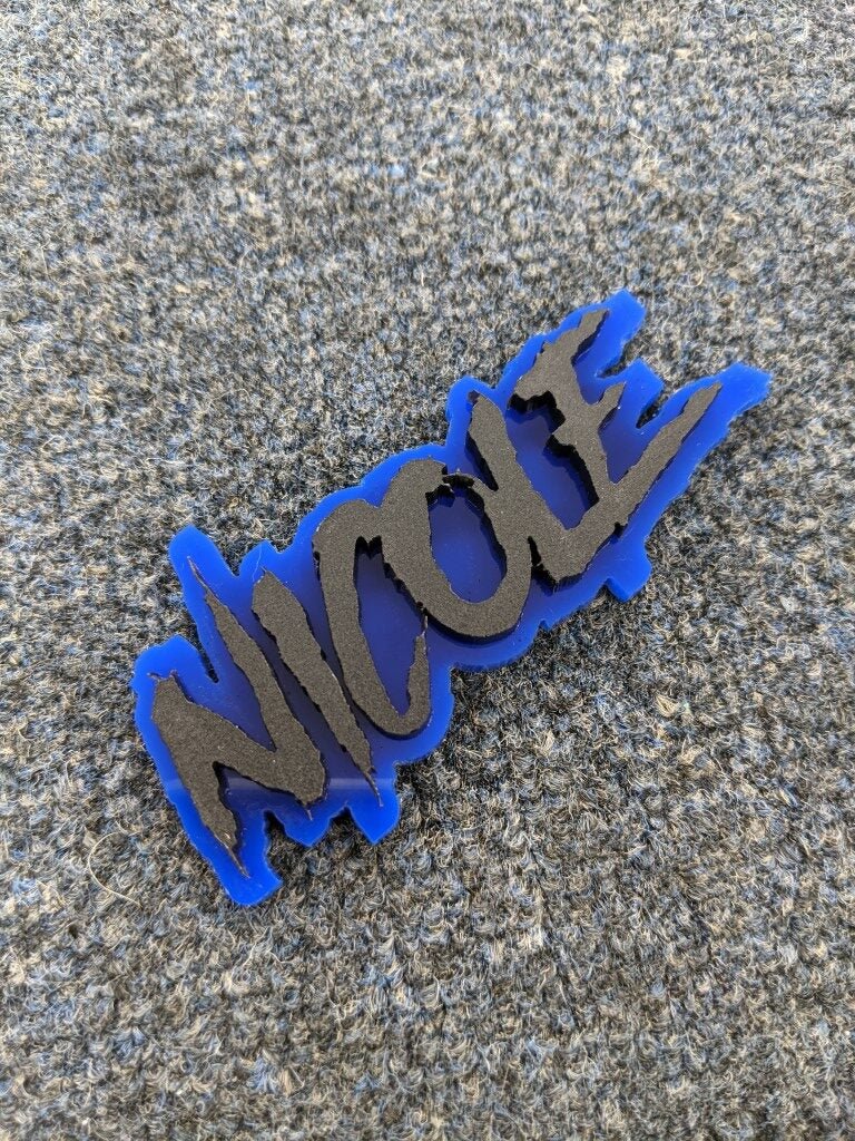 Nicole Car Badge - Matte Black On Blue - Aggressive Font - Atomic Car Concepts