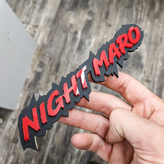 Night Mario Car Badge - Red on Matte Black - Lightning Font - Tape Mounting - Atomic Car Concepts