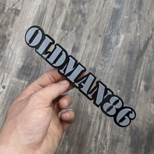 Oldman86 Car Badge - Grey on Matte Black - Stencil Font - Tape Mounting - Atomic Car Concepts