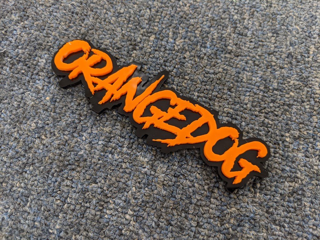 Orangedog Car Badge - Orange on Gloss Black - Aggressive Font - Tape Mounting - Atomic Car Concepts