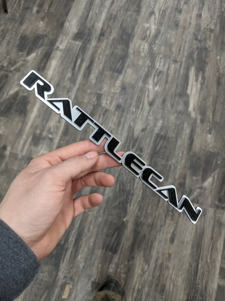 Rattlecan Car Badge - Gloss Black On Brushed Silver - OEM Font - Atomic Car Concepts