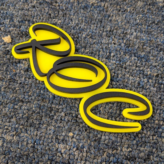 ROC Car Badge - Matte Black on Yellow - Script Font - Tape Mounting - Atomic Car Concepts