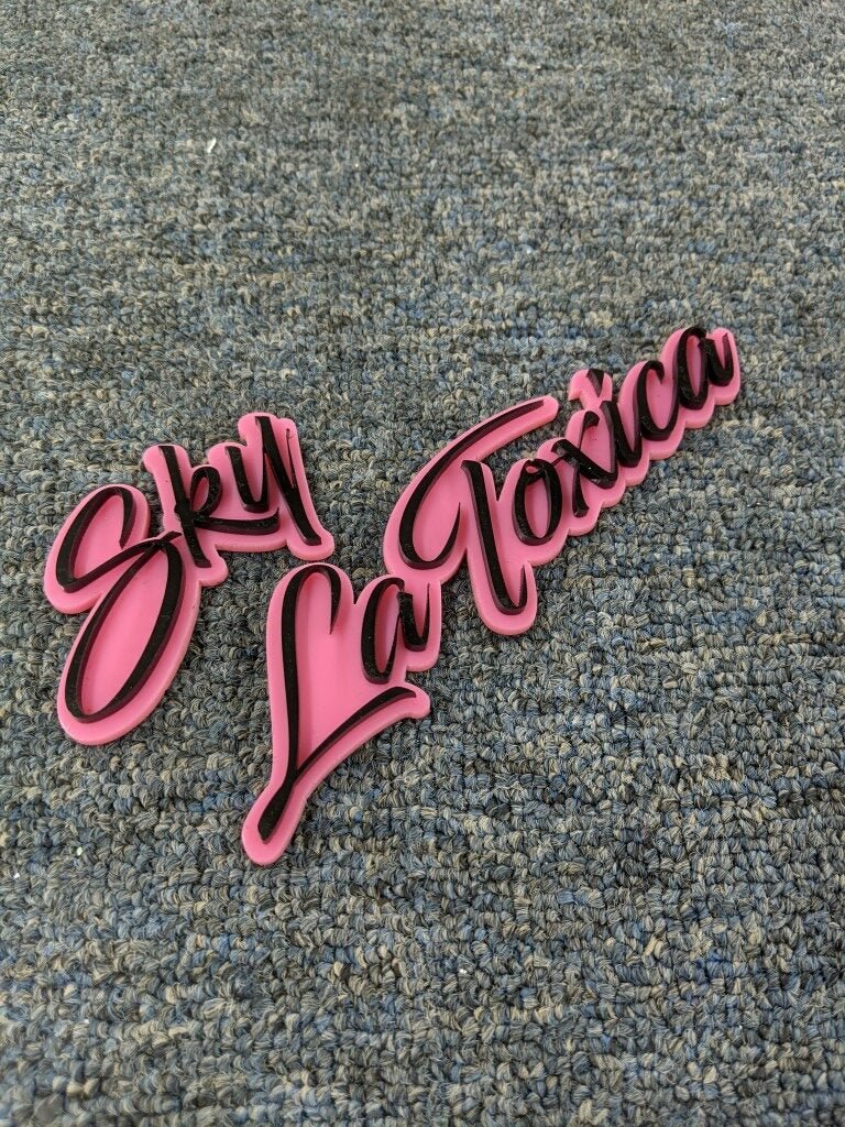 Sky La Toxica Car Badge - Gloss Black On Pink - Script Font - Atomic Car Concepts