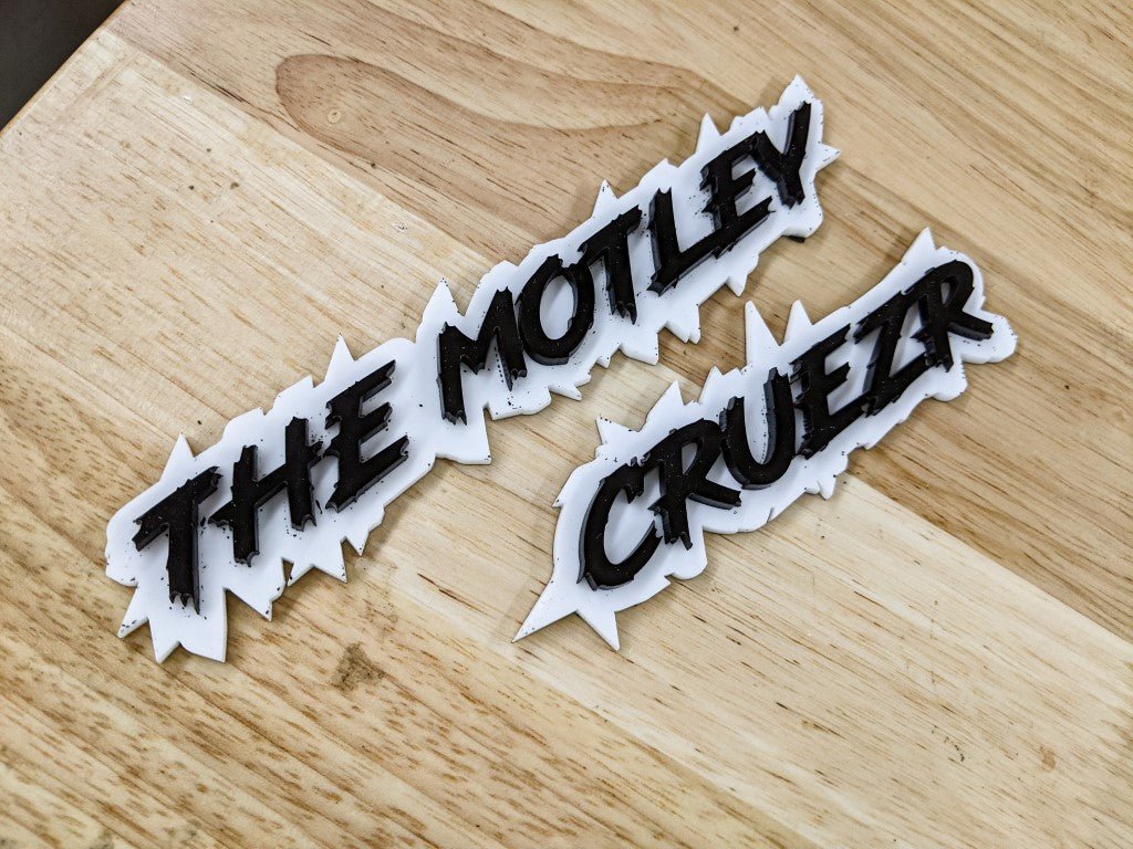 The Motley Cruezr Car Badge - Gloss Black on White - Lightning Font - Tape Mounting - Atomic Car Concepts