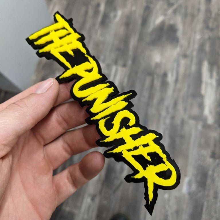 The Punisher Car Badge - Yellow on Gloss Black - Aggressive Font - Tape Mounting - Atomic Car Concepts