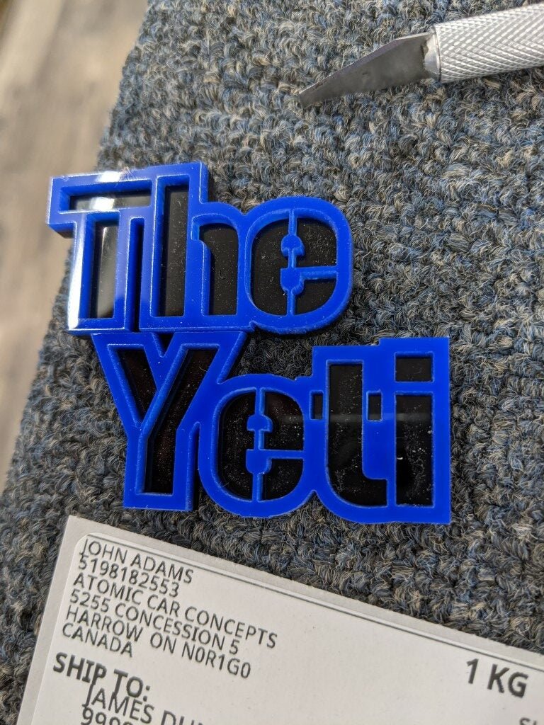 The Yeti Car Badge - Blue On Gloss Black - Stencil Font - Tape Mount - Atomic Car Concepts