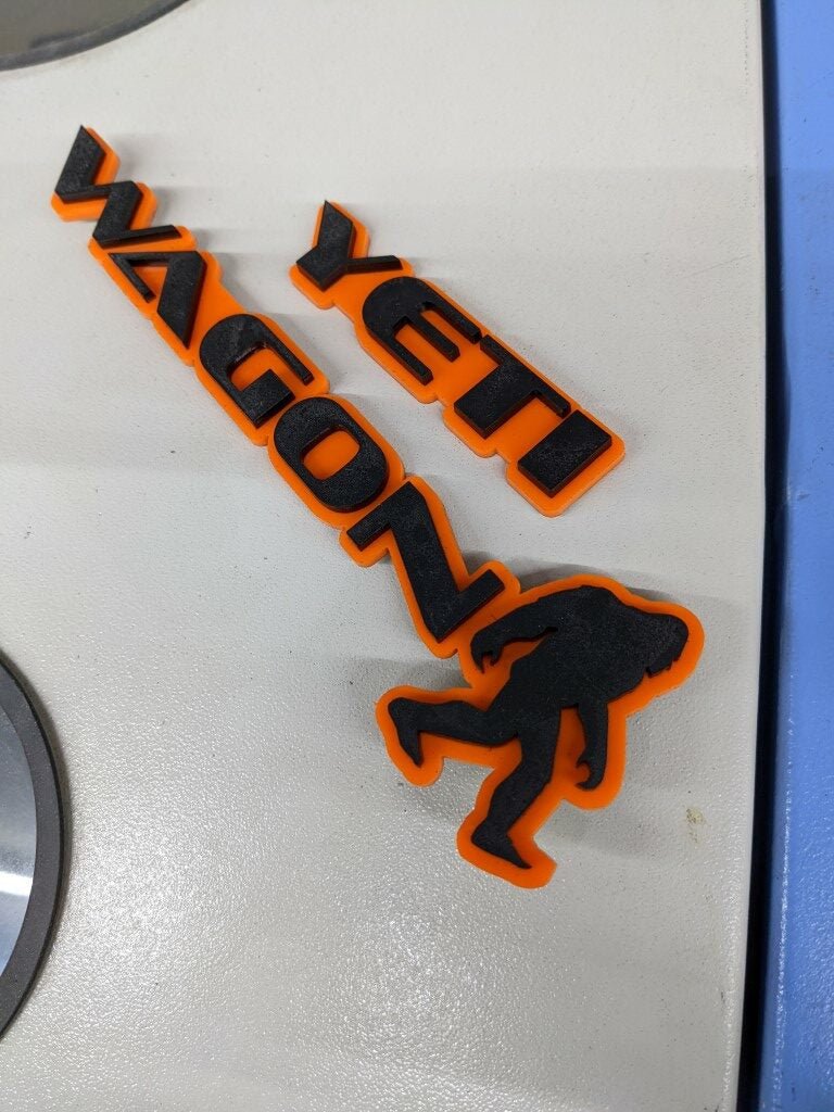 Yeti Wagon Car Badge - Gloss Black On Orange - OEM Font - Atomic Car Concepts